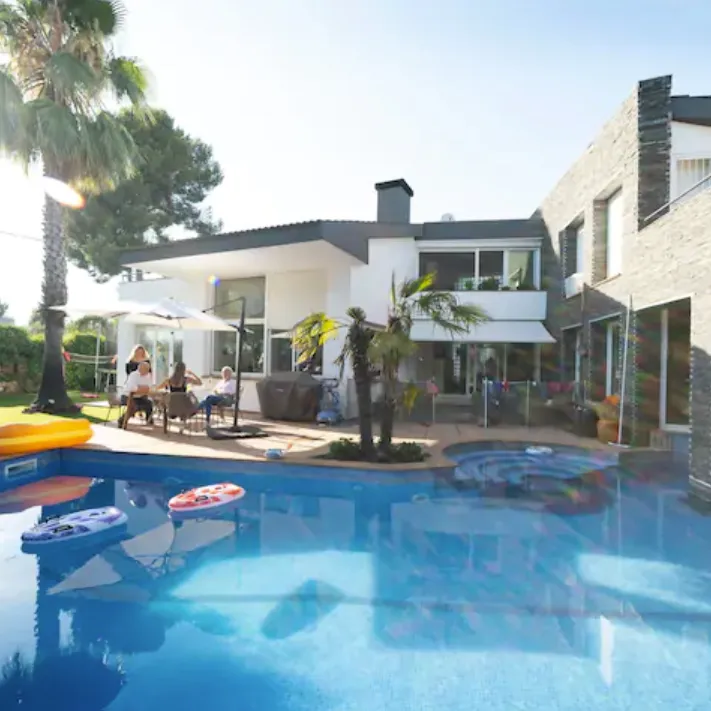 Modern villa with a swimming pool and palm trees